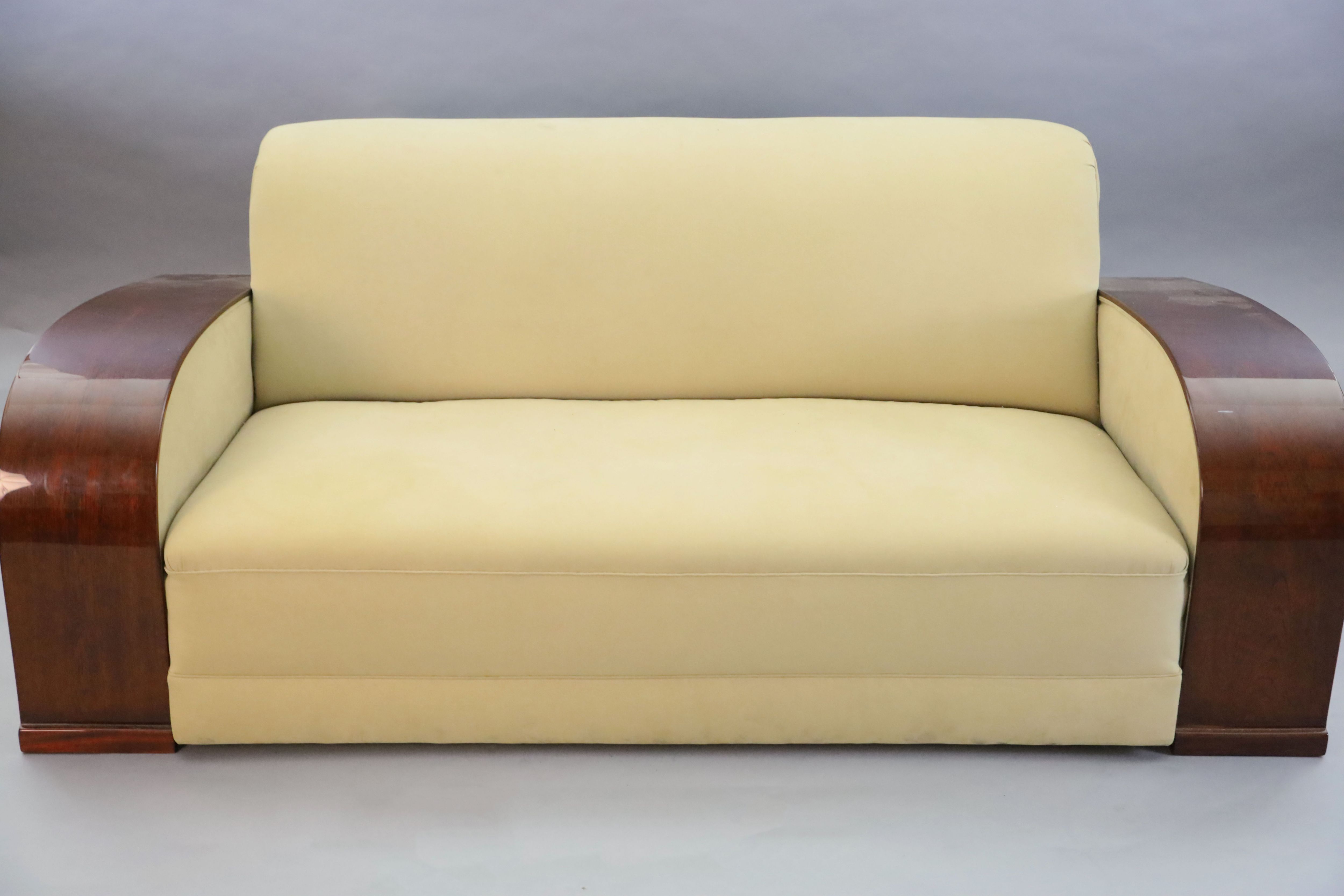 An Art Deco style mahogany and suede three piece suite, settee W.6ft 6in. D.3ft 4in. H.2ft 6in.
